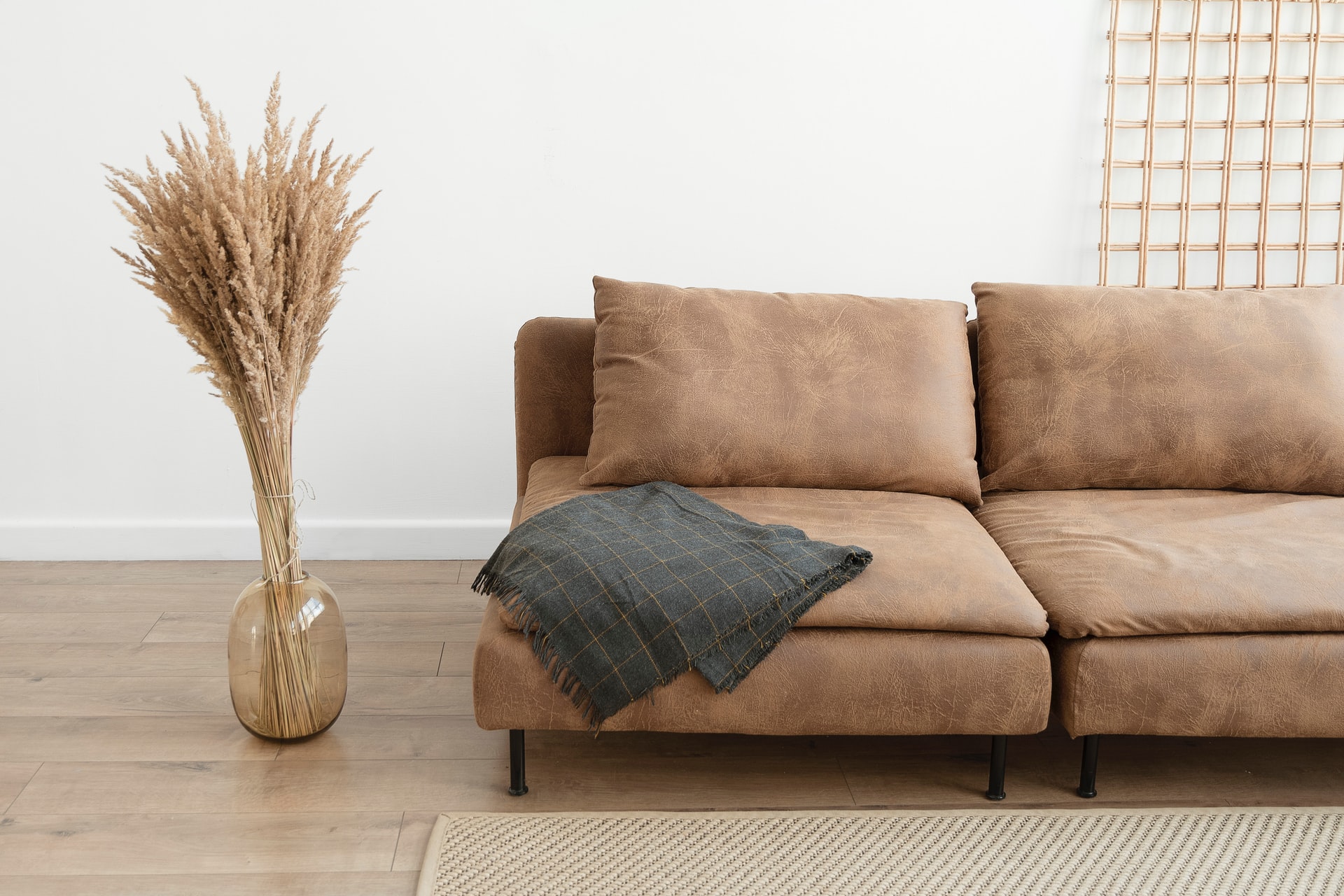 Photo of a brown couch against a white wall.