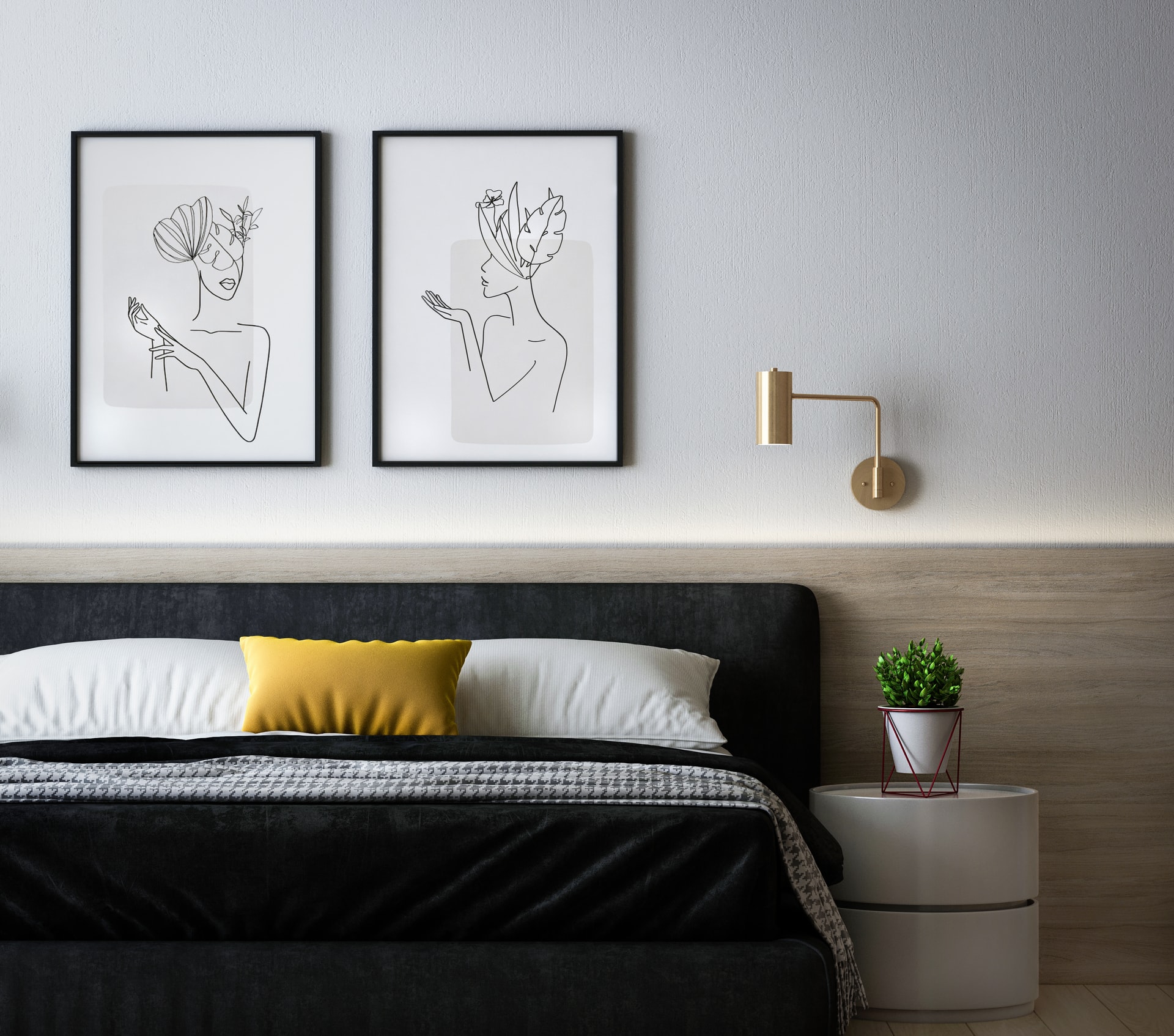 Photo of bedroom that has bed with a gray headboard and two framed photos on the wall above the bed.